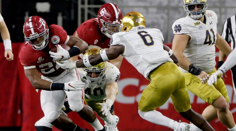 Alabama running back Najee Harris (22) runs the ball as Notre Dame linebacker Jeremiah Owusu-Koramoah (6) defends in the second half of the Rose Bowl NCAA college football game in Arlington, Texas, Friday, Jan. 1, 2021. (AP Photo/Michael Ainsworth)