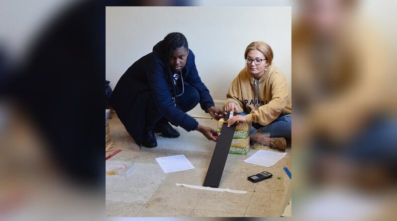 Preparing to launch a Gummy Bear, two high school students work together on getting the launch correct while a third stood by ready to measure the results. CONTRIBUTED/BOB RATTERMAN