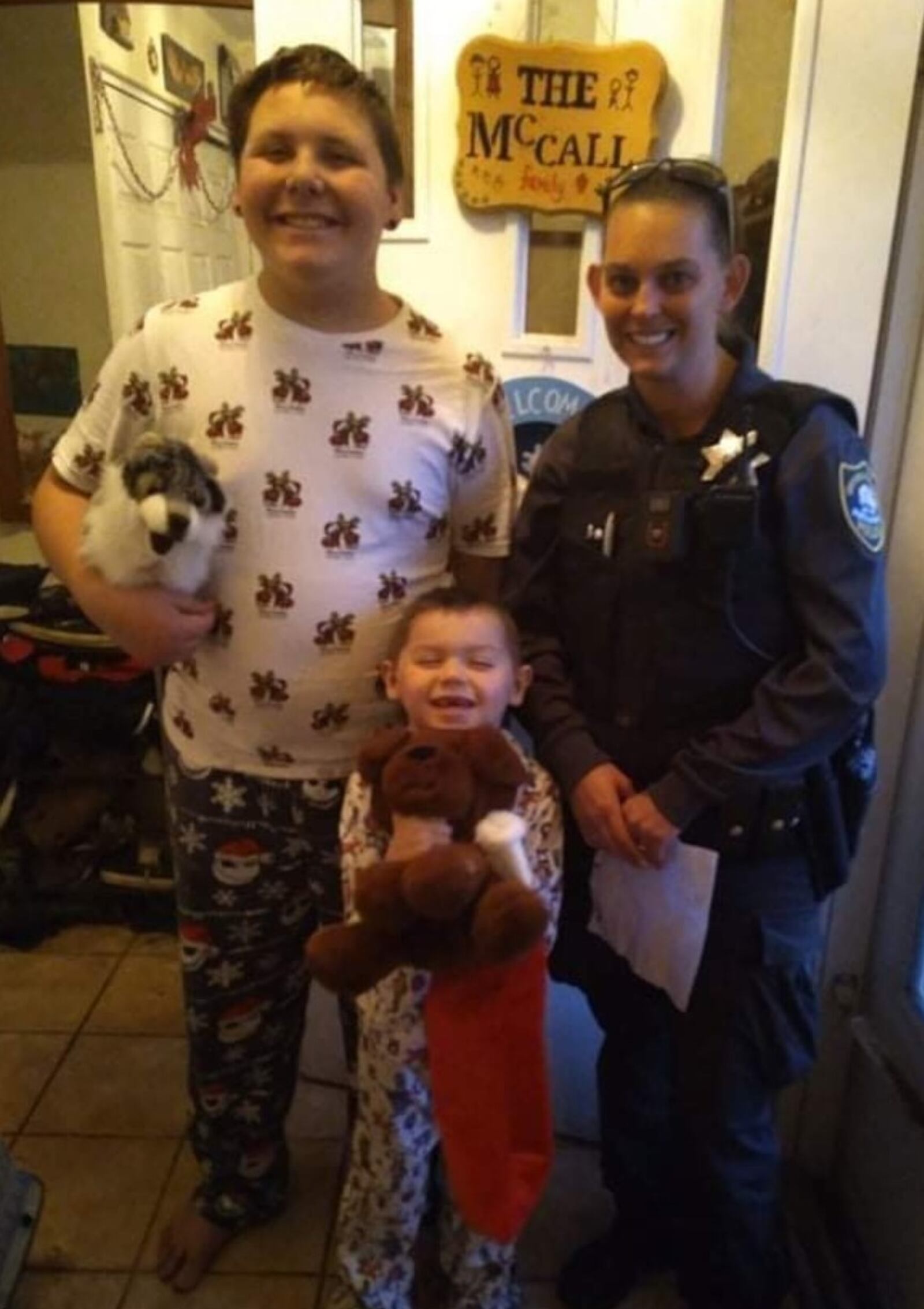 Gavin McCall and his brother are shown with Oxford Twp. Constable Cynthia Smith when she delivered coloring contest prizes on Christmas morning. CONTRIBUTED