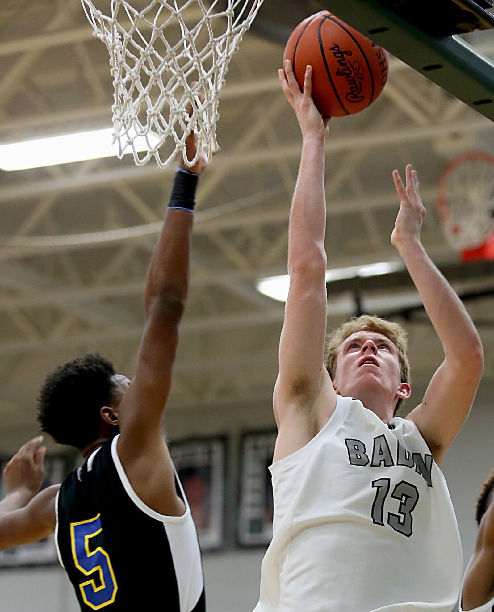 Badin wing Justin Pappas beats Northwest forward Kaleb Williams to the basket during Wednesday night’s game at Mulcahey Gym in Hamilton. CONTRIBUTED PHOTO BY E.L. HUBBARD