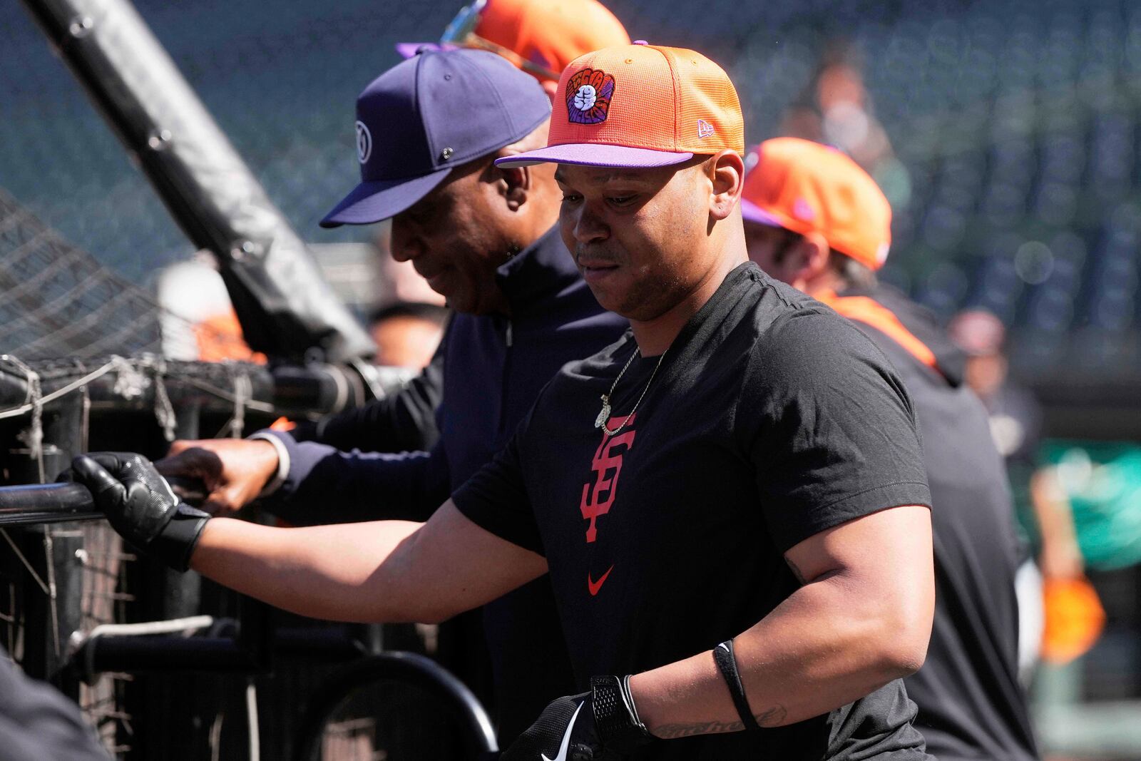 San Francisco Giants infielder Rafael Devers, foreground, waits to hit during batting practice after talking with former player Barry Bonds, left, before a baseball game between the Giants and the Cleveland Guardians in San Francisco, Tuesday, June 17, 2025. (AP Photo/Jeff Chiu)