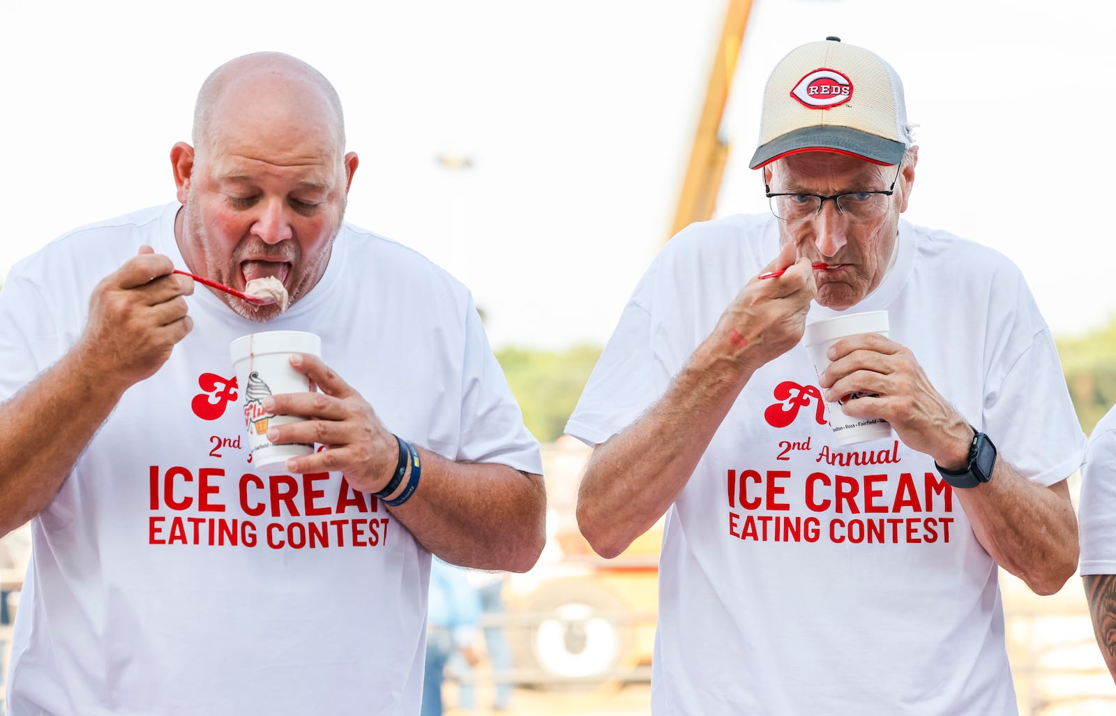 The Flub's 2nd Annual Ice Cream Eating Contest was held in front of the grandstand crowd during the Butler County Fair Tuesday, July 22, 2025 in Hamilton. The contestants had 10 minutes to eat as much ice cream as they could and down a slushie. The contest winner was awarded a $500 Flub's gift card. Hamilton city council member Joel Lauer, left, and mayor Pat Moeller try for victory. NICK GRAHAM/STAFF