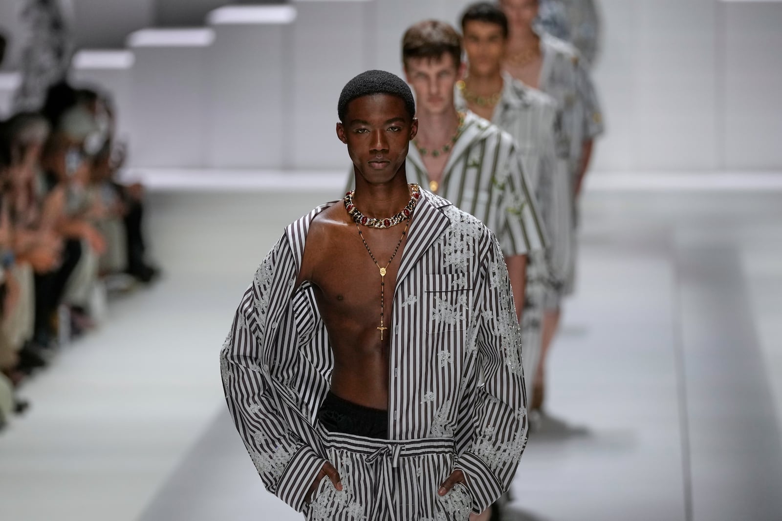 Models wear creations as part of the men's Dolce & Gabbana Spring-Summer 2026 collection, that was presented in Milan, Italy, Saturday, June 21, 2025. (AP Photo/Luca Bruno)