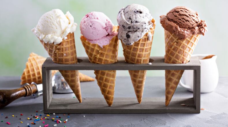 Variety of ice cream scoops in cones with chocolate, vanilla and strawberry. Getty Image