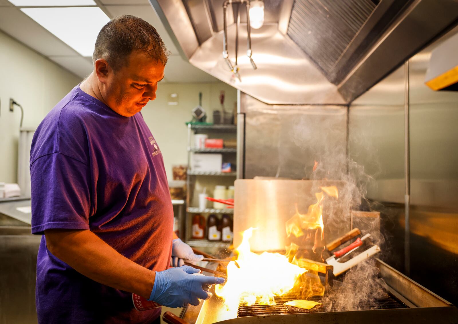 Brent Dalton cooks on the grill at his new location. Brent's Smokin' Butts & Grill has moved from their downtown location to a new location at 640 N University Blvd. in Middletown. NICK GRAHAM/STAFF