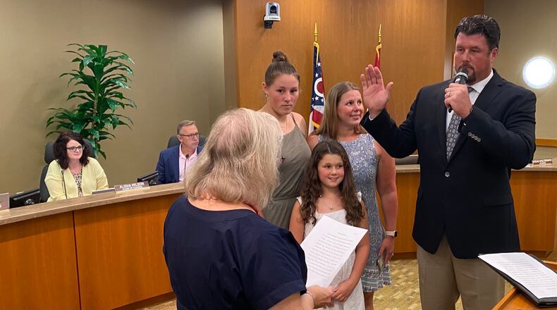 Adam Kraft is sworn in on Monday, August 8, 2022, as the newest member of Fairfield City Council. He was sworn in as the city’s Fourth Ward representative. He was accompanied by his family, to his right, which included (counter clockwise) his wife Tracy, and daughters Becca, 15, and Haylee, 9. Fairfield Municipal Court Judge Joyce Campbell (across from Kraft) administered the oath of office. MICHAEL D. PITMAN/STAFF