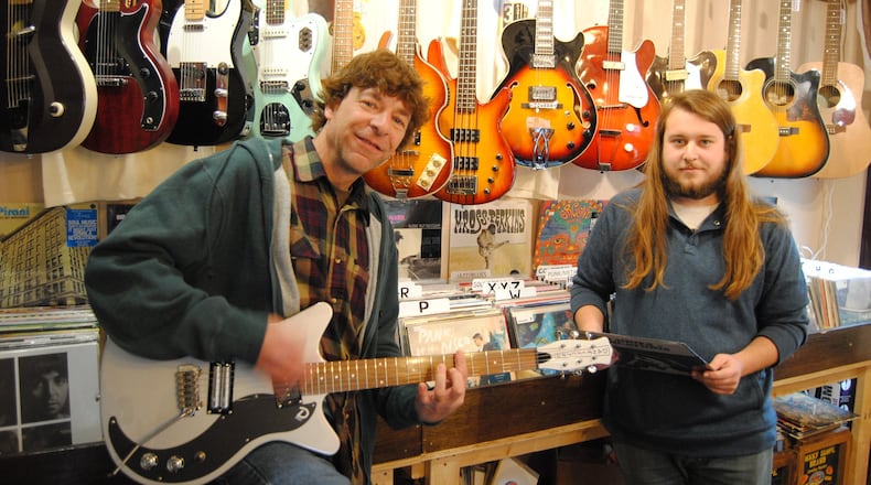 Pete Davidson and Miles Davidson, father-and-son co-owners of 3rd Street Music in Hamilton, one of dozens of businesses offering Small Business Saturday discounts in Butler County. ERIC SCHWARTZBERG/STAFF