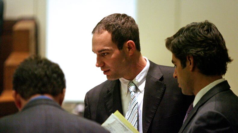 FILE PHOTO: Ryan Widmer, center, stands with his defense attorneys Jay Clark, left, and Charlie M. Rittgers during a break in jury selection Jan. 19, 2011, in Warren County Common Pleas Court in Lebanon, Ohio.