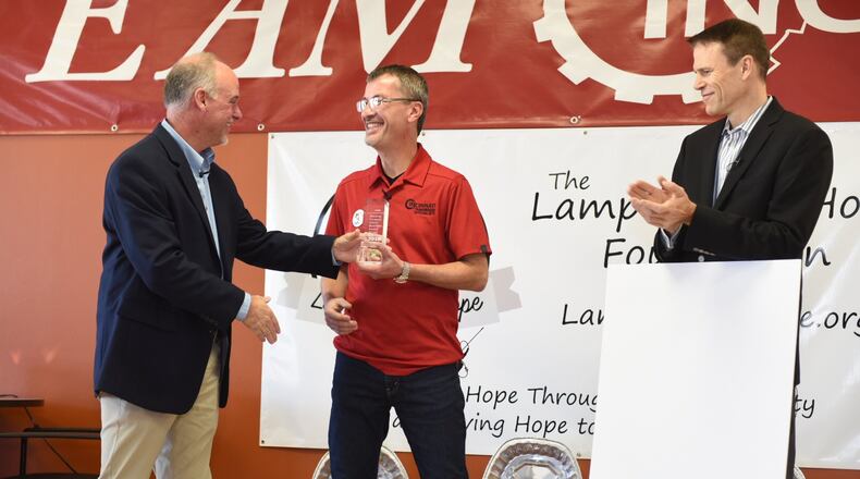 Rick Lamping, center, is the founder and president of Cincinnati Transmission Specialists Inc. He and his family have been life-long philanthropists. He and the company created a new non-profit foundation, The Lamplight of Hope, to help provide for families affected by disability, illness and other hardships. The Lamplight of Hope Foundation just provided Thanksgiving Dinner Boxes to more than 40 families.