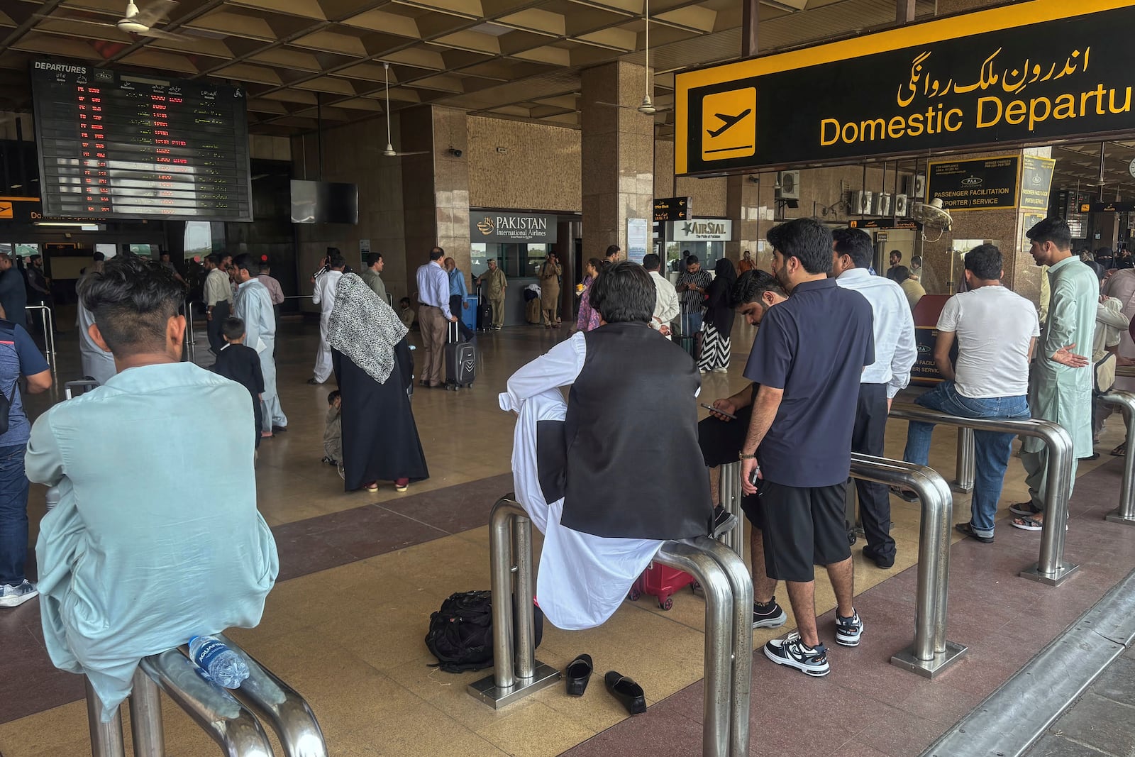 Stranded passengers wait at an arrival area of Jinnah airport after authorities closed the airport due to India's drone attack to Pakistan, in Karachi, Pakistan, Thursday, May 8, 2025. (AP Photo/Mohammad Farooq)
