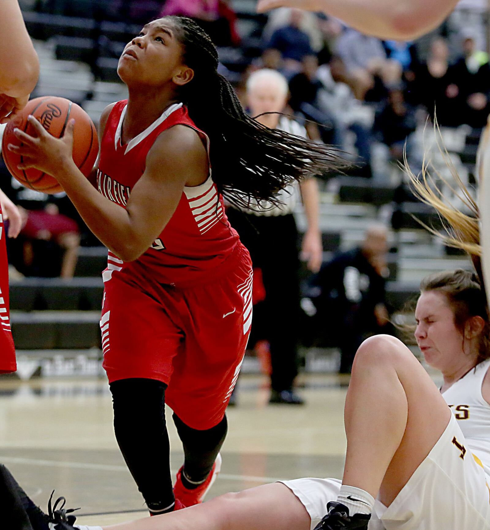Fairfield guard Journee Hicks eyes the basket as Turpin guard Kaitlyn Workman hits the floor Thursday night during a Division I sectional semifinal at Lakota East. CONTRIBUTED PHOTO BY E.L. HUBBARD