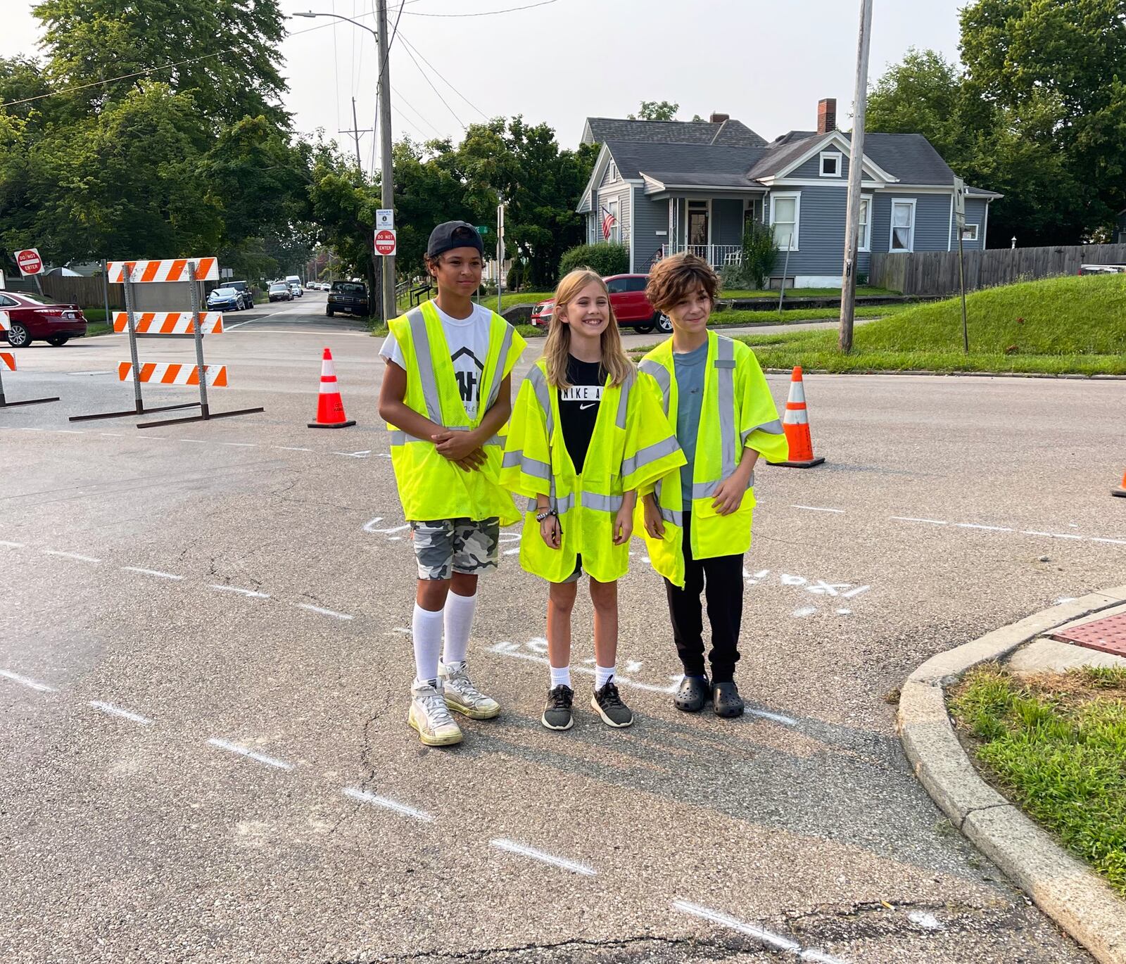 Three Hamilton Highland Elementary 6th graders just made walking to and from school safer for hundreds of classmates with their grant-seeking project that saw the recent creation of a new cross walk. The now 7th graders wrote and pitched for local grant funds to help the city create the new cross walk. Pictured here (L-R) at the crosswalk dedication, which was attended by Hamilton Mayor Pat Moeller, are Xavier Hoxie, Malin Matheny and Kamyn Frazier. (Provided Photo\Journal-News)