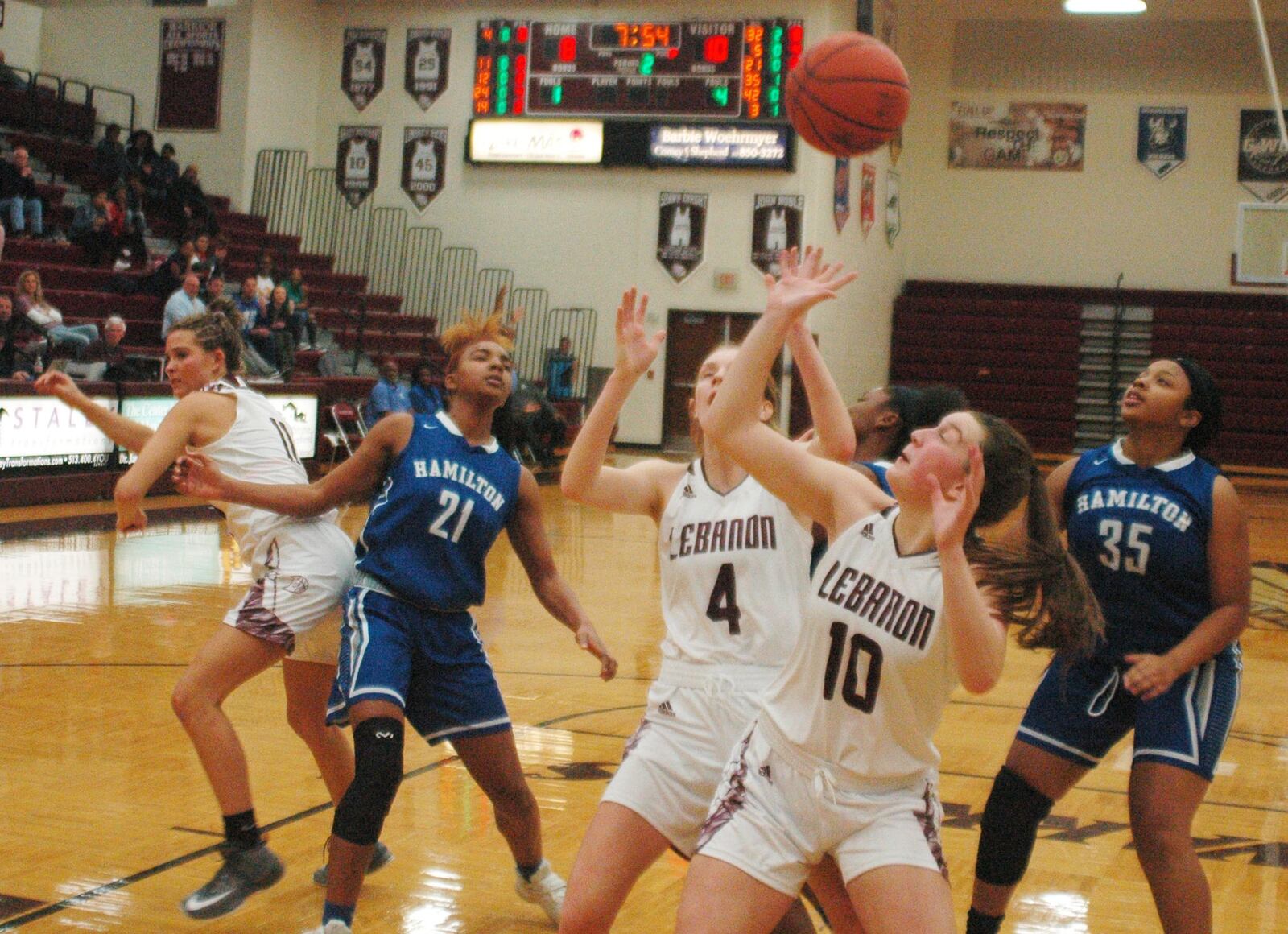 Lebanon’s Molly Lane (4), Isabella Dunn (10) and Ashley West (11) are in the mix for a rebound with Hamilton’s CiCi Riggins (21) and Akira Sneed (35) during Monday night’s game at Lebanon. Hamilton posted a 52-42 victory. RICK CASSANO/STAFF