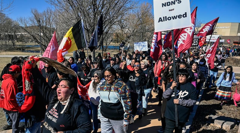 FILE - Demonstrators march from Memorial Park to the Andrew W. Bogue Federal building on Wednesday, March 23, 2022, in Rapid City, S.D., where it was announced that a federal civil rights lawsuit was filed against the Grand Gateway Hotel for denying services to Native Americans. (Matt Gade/Rapid City Journal via AP, File)