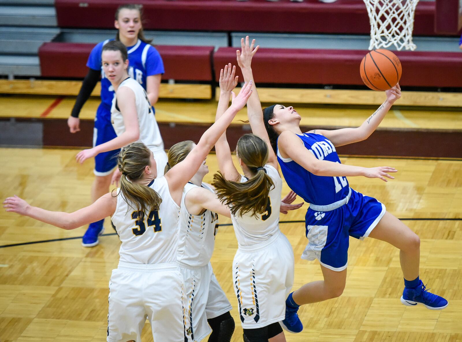 Dunbar's Alexis Lynn is fouled as she drives to the hoop during Thursday night’s Division II sectional game against Monroe at Lebanon. NICK GRAHAM/STAFF