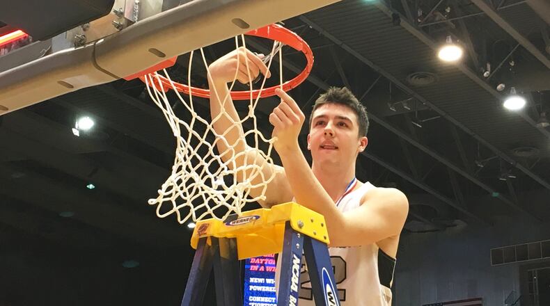 Lakota East’s Bash Wieland cuts down the net after the Thunderhawks defeated Fairmont 50-36 to win a Division I district basketball championship March 9, 2019, at the University of Dayton Arena. RICK CASSANO/STAFF