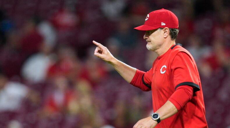 Cincinnati Reds manager David Bell signals to the bullpen during the seventh inning of the team's baseball game against the St. Louis Cardinals on Wednesday, Aug. 31, 2022, in Cincinnati. (AP Photo/Jeff Dean)