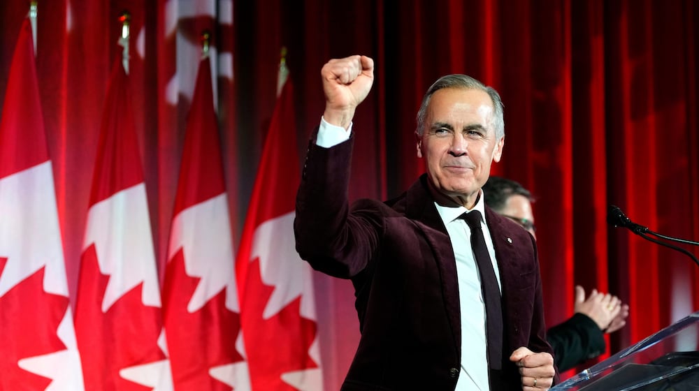 FILE - Canada's Prime Minister Mark Carney pumps his fist as he arrives to deliver remarks at the Liberal caucus holiday party in Ottawa, on Thursday, Dec. 11, 2025. (Justin Tang/The Canadian Press via AP, File)