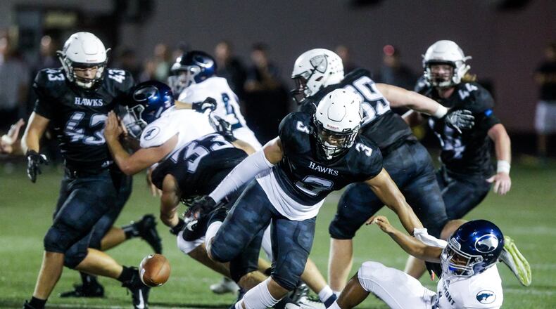 Lakota East’s Jordell Smith (3) knocks the ball loose from Fairmont quarterback Malek Hillon during their football game Friday, Sept. 6 at Lakota East High School in Liberty Township. Fairmont recovered the ball. Lakota East won 14-6. NICK GRAHAM/STAFF