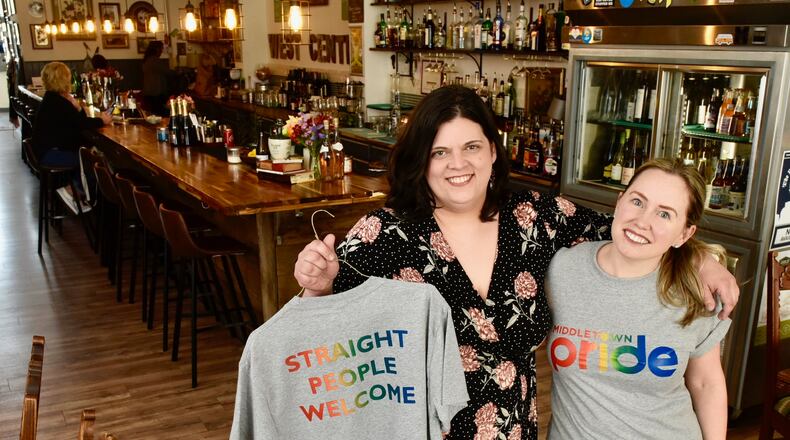 Melissa Kutzera, left, and Monica Nenni, owners of West Central Wine show off shirts being sold to raise money for the upcoming pride parade Tuesday, April 16 in Middletown. NICK GRAHAM/STAFF