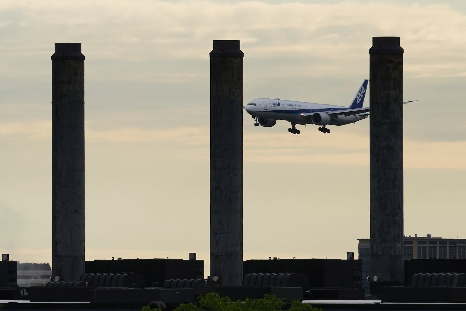 An ANA airline plane descends into landing at O'Hare International Airport in Chicago, Friday, May 23, 2025. (AP Photo/Nam Y. Huh)