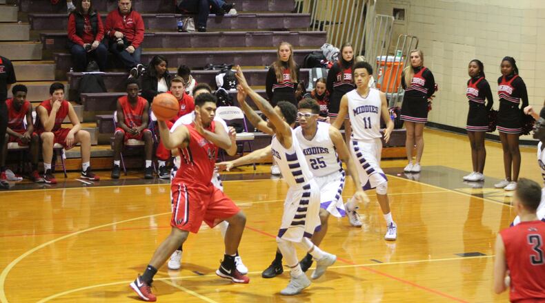 Middletown’s Nelson Rutledge, Jawunn Bailey (25) and Cliff Snow (11) play defense as Lakota West’s Malachi Hughes (44) makes a pass on Jan. 10 at Wade E. Miller Gym in Middletown. CONTRIBUTED PHOTO BY MARITZA MCKINNEY