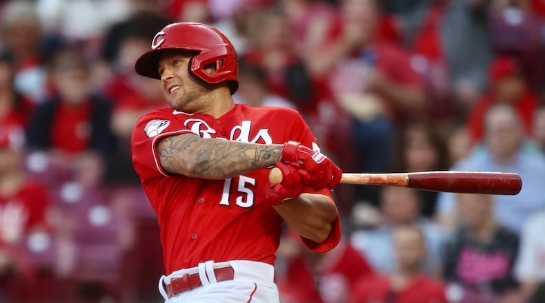 Nick Senzel, of the Reds, singles to drive in a run in the fourth inning against the White Sox on Friday, May 5, 2023, at Great American Ball Park in Cincinnati. David Jablonski/Staff