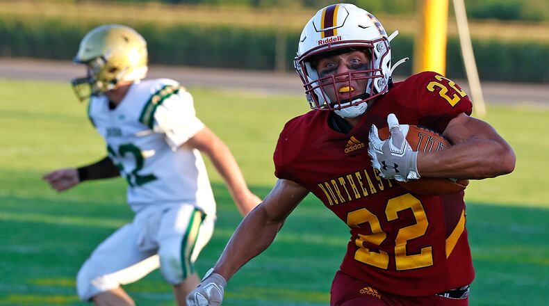 Northeastern's Garrett Chadwell carries the ball for a first down against Catholic Central during Friday's game. BILL LACKEY/STAFF