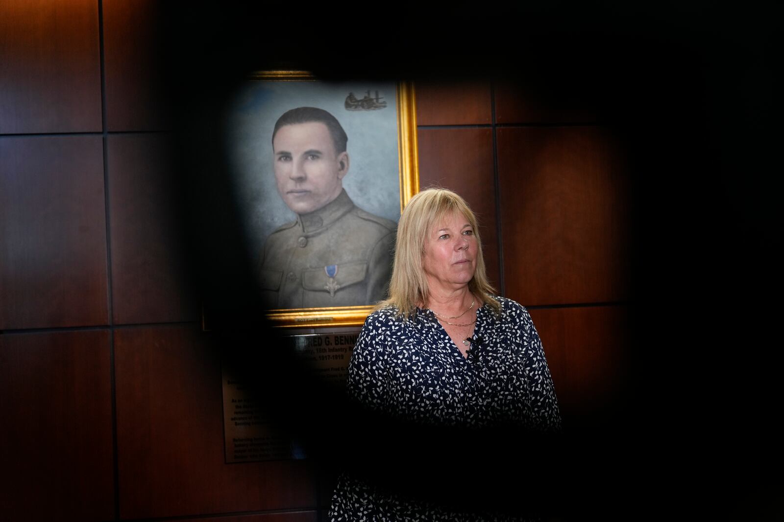 Ms. Sue Conger-Williams, Fred Benning's granddaughter gives and interview in front of her grandfathers portrait hanging at Fort Benning during a ceremony honoring new namesake on Wednesday, April 16, 2025, in Fort Benning, Ga. (AP Photo/Brynn Anderson)