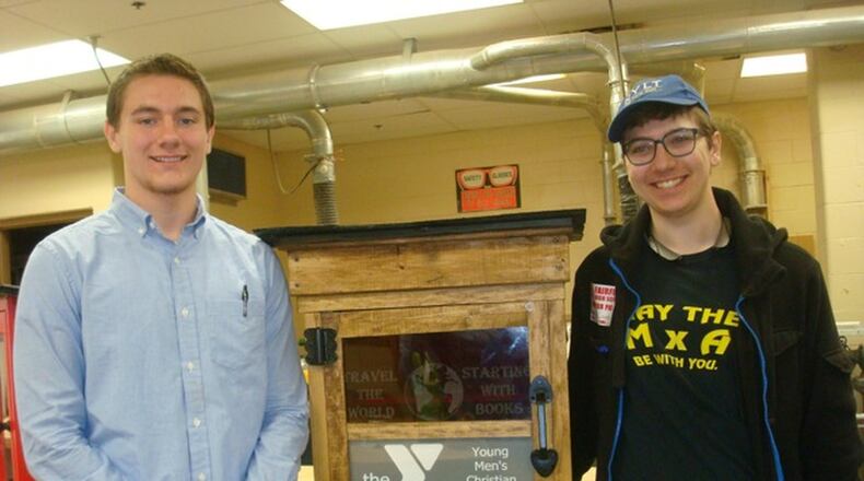 Butler Tech students T.J. Icenogle and Isaac Gruver with the Fairfield YMCA Little Free Library donation. CONTRIBUTED