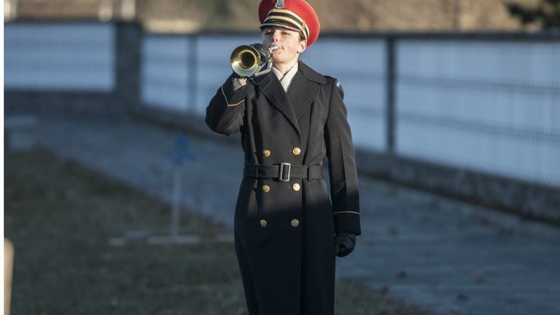 Staff Sgt. Adrienne Doctor plays taps during the dedication ceremony for the Tomb of Remembrance in Section 72 of Arlington National Cemetery, Arlington, Virginia, Dec. 13, 2017. (U.S. Army photo by Elizabeth Fraser)