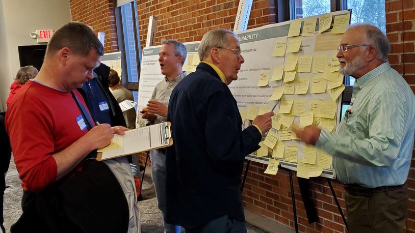 Steve Dana talks to Mark Boardman (right) about the sustainability issues posted on the board at Monday’s visioning workshop as the second public meeting in the development of an update for the city’s Comprehensive Plan. CONTRIBUTED/BOB RATTERMAN