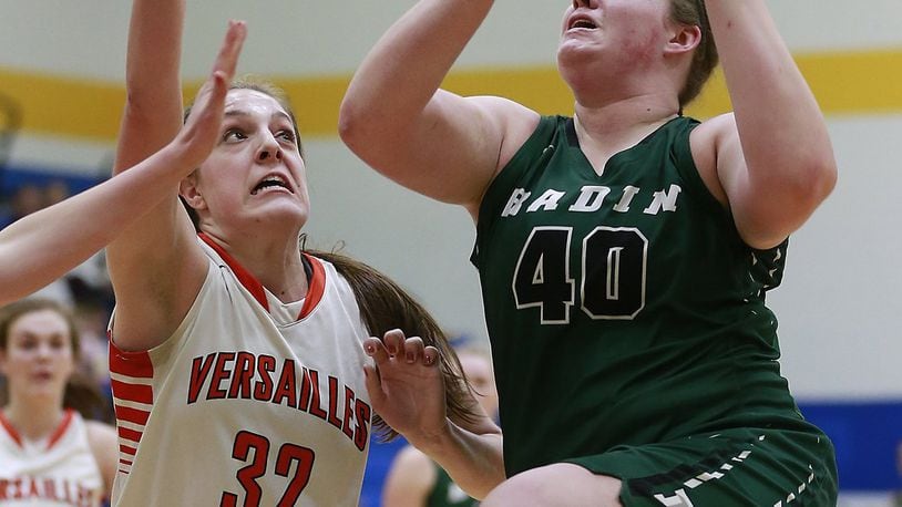 Badin’s Emma Broermann goes up for two points under pressure from Versailles’ Danielle Winner during a Division III regional semifinal March 8, 2017, at Springfield. BILL LACKEY/STAFF