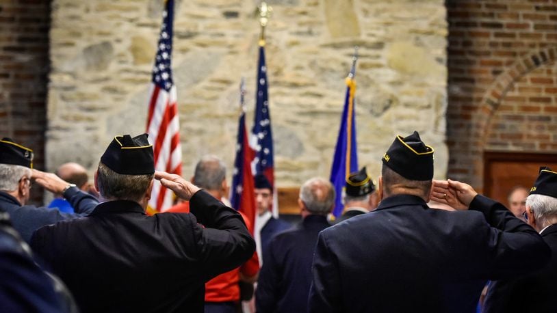 Veterans stand at attention during the singing of the national anthem at the annual Butler County Veterans Day program this year in Hamilton.