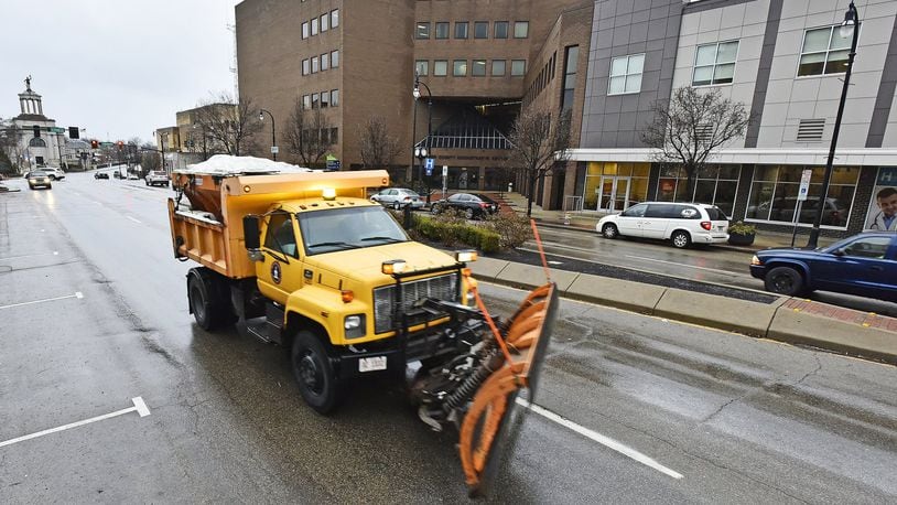 Hamilton residents starting in January will be able to go online to see what streets have been salted or recently cleared by snow plows. Here, a snow plow truck applied salt in 2017 to High Street as freezing rain started to fall. NICK GRAHAM/STAFF
