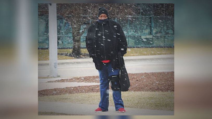 A man waited for the bus on Patterson Boulevard on a snowy morning on Thursday, Jan. 28, 2021. MARSHALL GORBY\STAFF