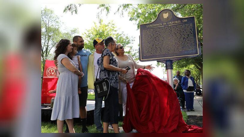Miami University and Oxford city officials unveiled a new historic marker in an Uptown city park recognizing the racist legacy of lynching and mob violence against two local African American men. The 19th Century deaths are described on the marker and decedents of the two men are pictured here at the Monday unveiling ceremony. (Provided Photo\Journal-News)