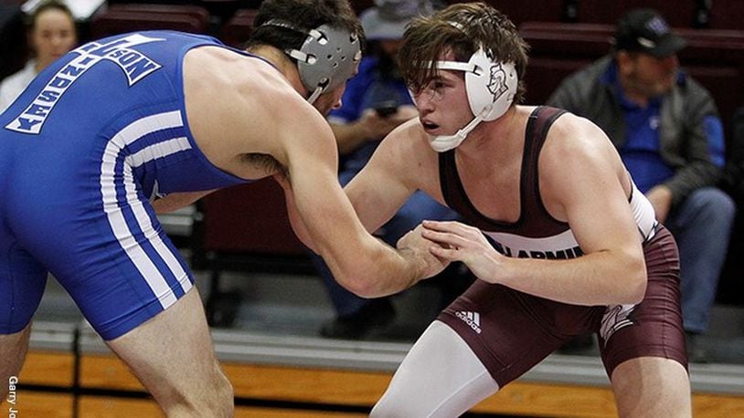 Bellarmine’s Andrew Sams (right) competes against Lindsey Wilson’s Lucas Miozza on Dec. 6 at Knights Hall in Louisville, Ky. Sams won the 184-pound match 6-3. PHOTO COURTESY OF BELLARMINE ATHLETICS