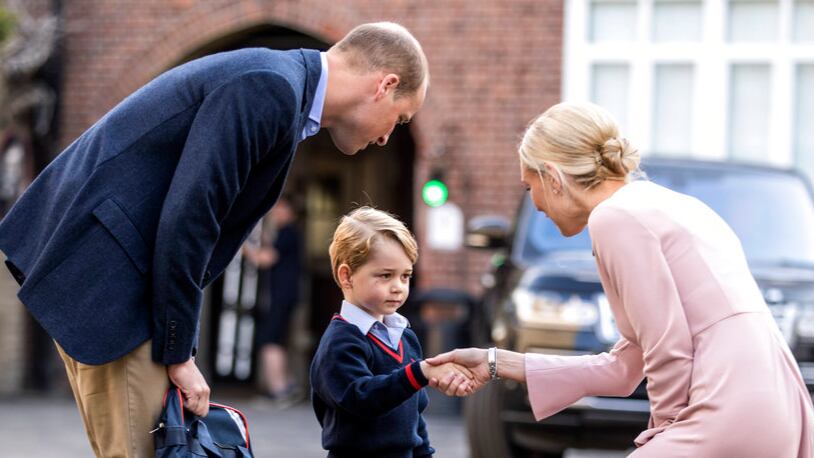 Britain's Prince William accompanies Prince George as he is greeted by Helen Haslem - the head of the lower school as he arrives for his first day of school at Thomas's school in Battersea, London, Thursday, Sept. 7, 2017.  Prince William's pregnant wife Kate was too ill with morning sickness Thursday to take young Prince George to his first day of school.  (Richard Pohle/Pool Photo via AP)