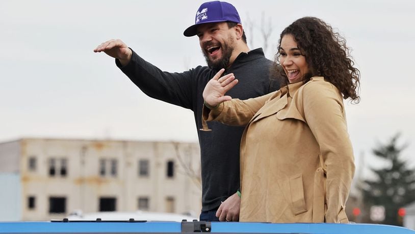 Kyle Schwarber and wife, Paige, wave at the crowd during the Middletown Santa Parade Saturday, Nov. 26, 2022 in downtown Middletown. Middletown native Kyle Schwarber served as grand marshal. NICK GRAHAM/STAFF