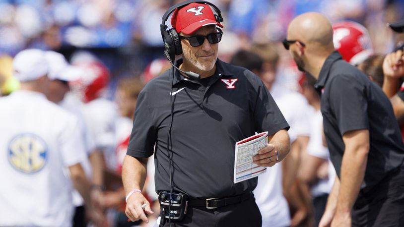 Youngstown State head coach Doug Phillips looks at his play sheet during the first half of an NCAA college football game against Kentucky in Lexington, Ky., Saturday, Sept. 17, 2022. (AP Photo/Michael Clubb)