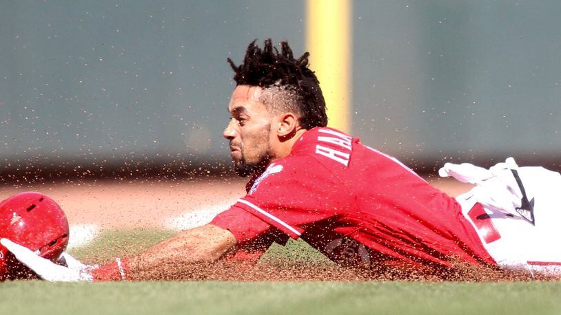 Billy Hamilton slides into third with a triple against the Giants on Sunday, May 7, 2017, at Great American Ball Park in Cincinnati. David Jablonski/Staff