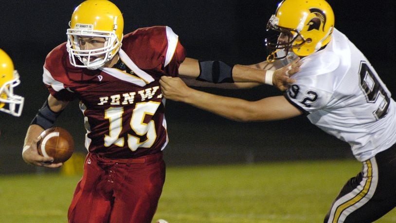 Fenwick quarterback Joe Murphy avoids a tackle attempt by Roger Bacon’s Luke Sunderman during a game at Krusling Field on Aug. 26, 2005. NICK GRAHAM/STAFF