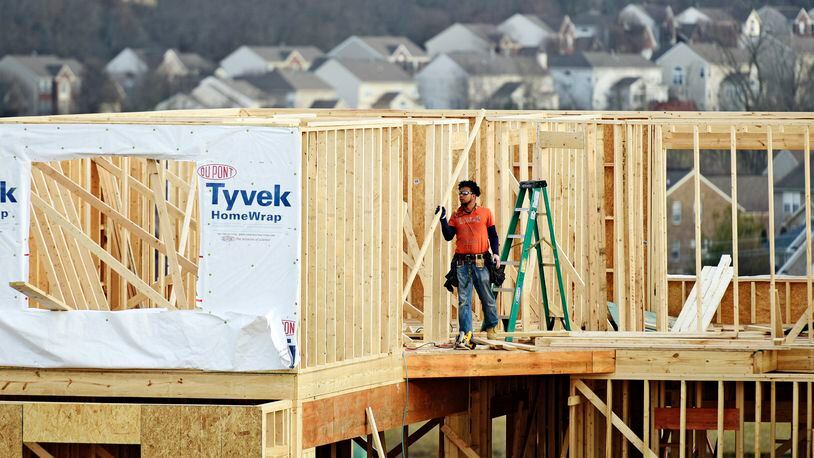 A crew works on construction of a new home on Elm Leaf Trail Monday, Feb. 20, 2017 in Liberty Township. NICK GRAHAM/STAFF