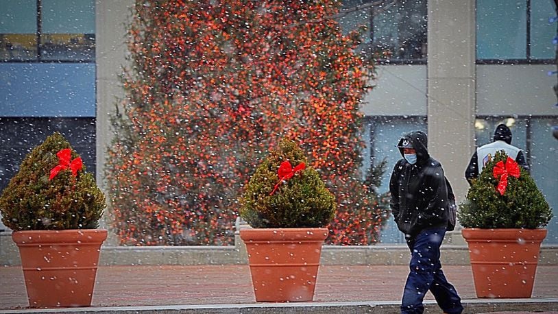 A little snowfall on Christmas Eve day at Courthouse Square in Dayton. MARSHALL GORBY\STAFF