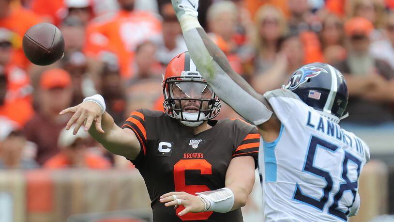 Cleveland Browns quarterback Baker Mayfield gets off a fourth quarter pass while being pressured by Tennessee Titans’ Harold Landry III on Sunday, Sept. 8, 2019 in Cleveland, Ohio, at FirstEnergy Stadium. The Browns lost the game 43-13. (Phil Masturzo/Akron Beacon Journal/TNS)