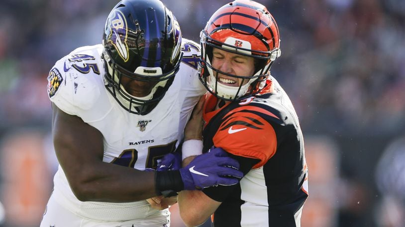 CINCINNATI, OHIO - NOVEMBER 10: Ryan Finley #5 of the Cincinnati Bengals is tackled by Jaylon Ferguson #45 of the Baltimore Ravens during the second quarter of the game at Paul Brown Stadium on November 10, 2019 in Cincinnati, Ohio. (Photo by Silas Walker/Getty Images)