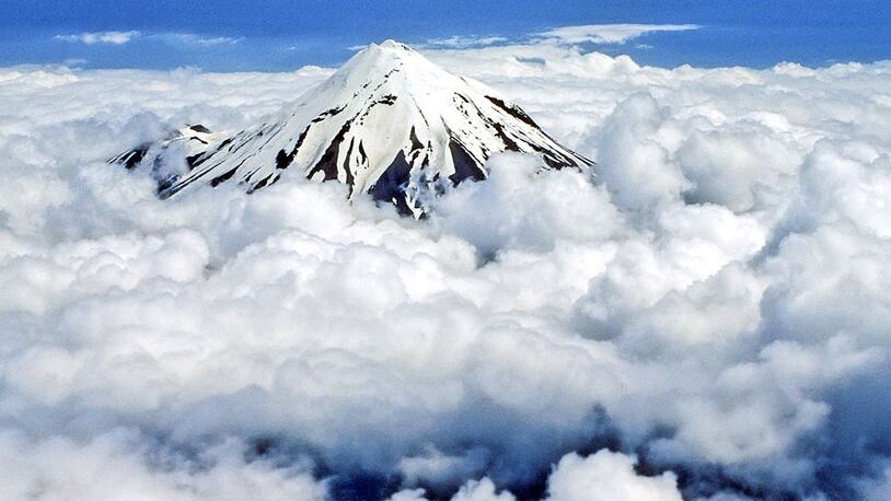Mt Taranaki Egmont, 2518m above sea level, seen above clouds, Cone shaped dormant volcano, Composite, Aerial, Taranaki, New Zealand. (Photo by Education Images/UIG via Getty Images)