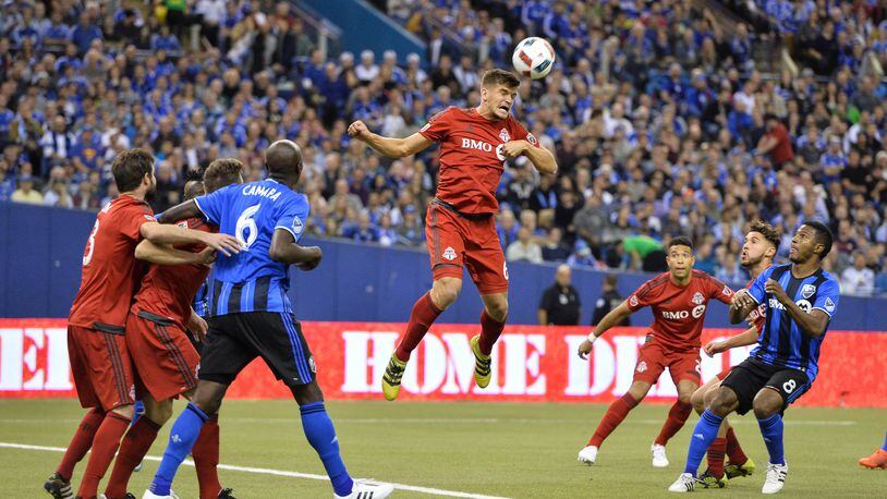 MONTREAL, QC - NOVEMBER 22: Nick Hagglund #6 of the Toronto FC jumps to play the ball during leg one of the MLS Eastern Conference finals against the Montreal Impact at Olympic Stadium on November 22, 2016 in Montreal, Quebec, Canada. (Photo by Minas Panagiotakis/Getty Images)