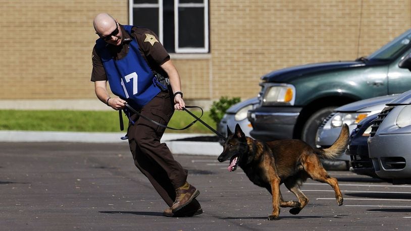 Police officers and their canine partners from several states participate in the United States Police Canine Association region 5 trials Monday, May 16, 2022 at Berachah Church in Middletown. NICK GRAHAM/STAFF